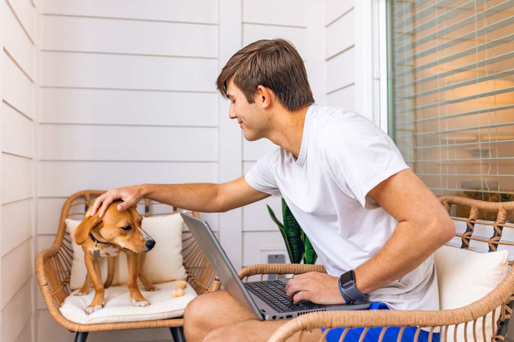 Resident with his dog in a living room at The Waters at Promenade in Marrero, Louisiana