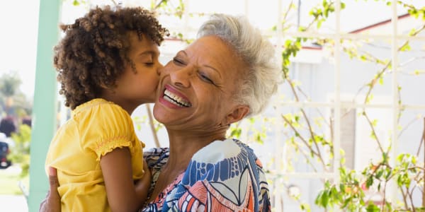 Resident getting kissed on the cheek by her grandchild at Edgerton Care Center in Edgerton, Wisconsin