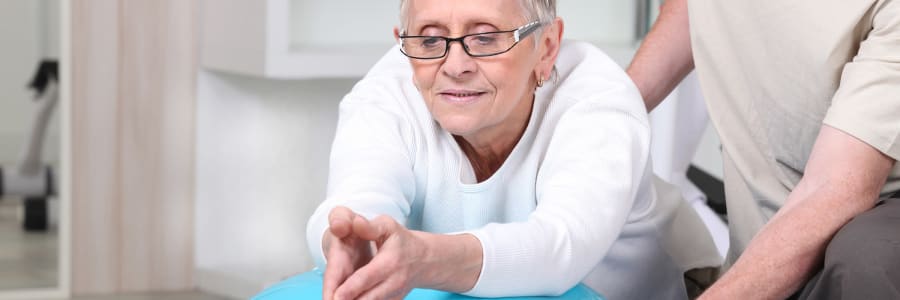 Resident working with a exercise ball at Maple Ridge Care Center in Spooner, Wisconsin