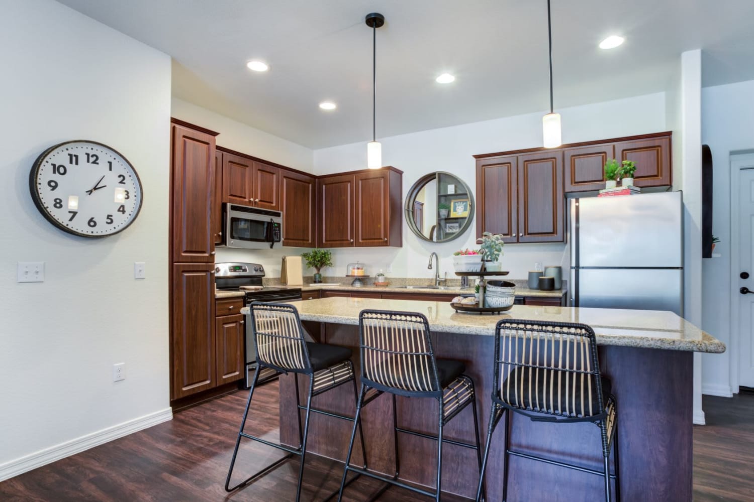 Upscale model kitchen with an island and pendant lighting at San Marquis in Tempe, Arizona