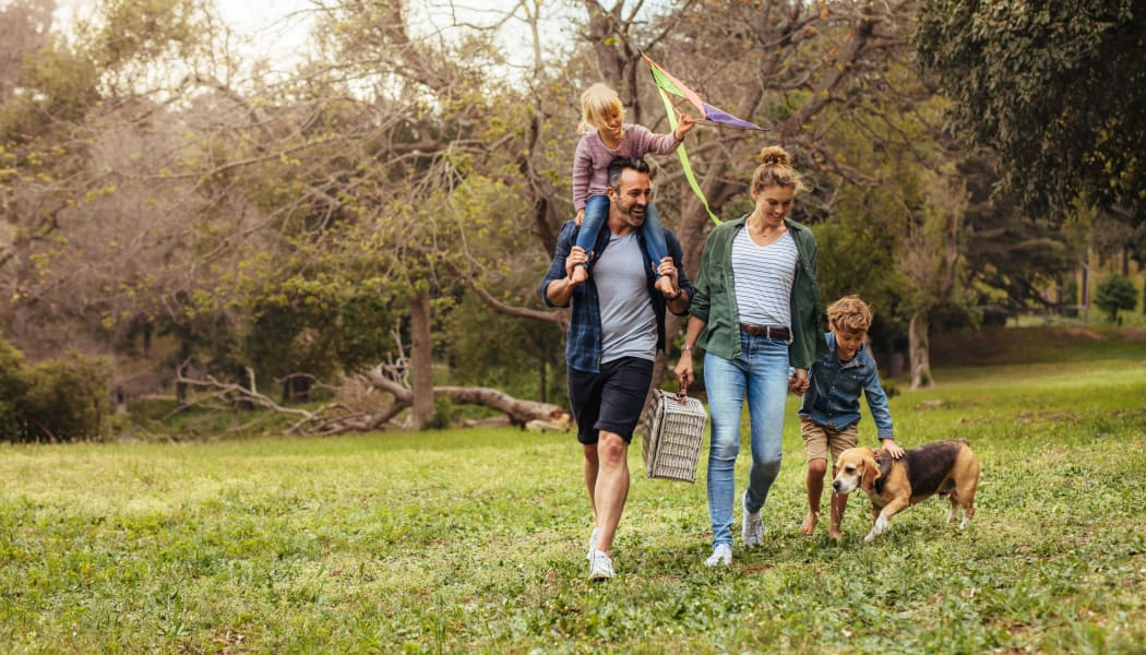 Family walking their dog in Waco, Texas near Tuscany Ranch