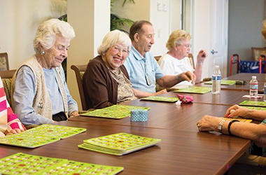 Group of residents at Burr Ridge Senior Living enjoying a game of bingo