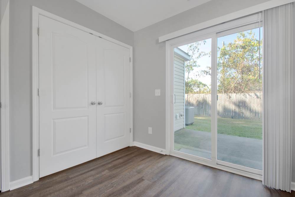 Sliding glass door to outdoor patio at Crystal Lake & Kingsley Apartments and Townhomes in Fayetteville, North Carolina