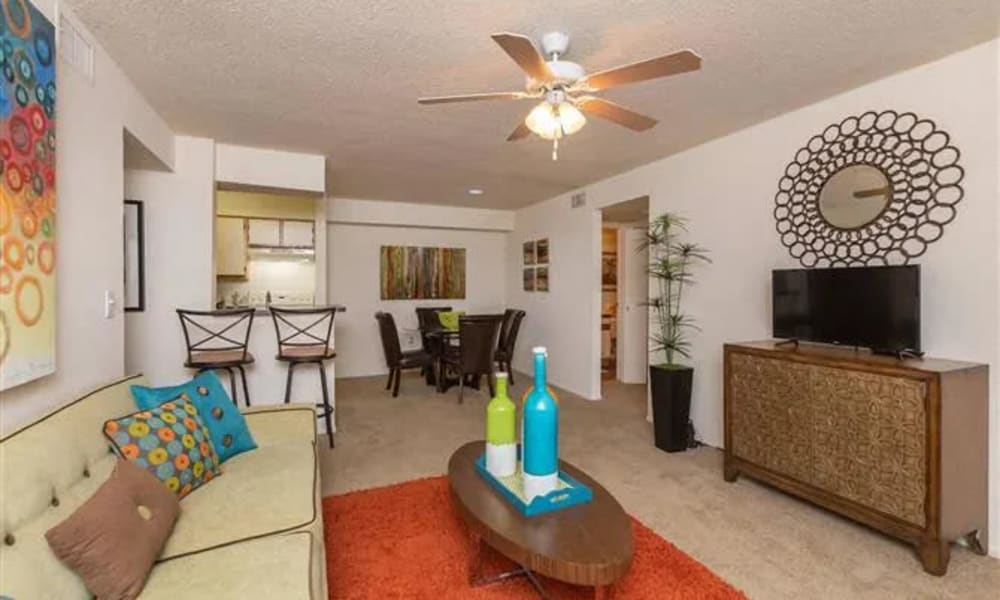 A furnished apartment living room with a ceiling fan at The Granite at Porpoise Bay in Daytona Beach, Florida