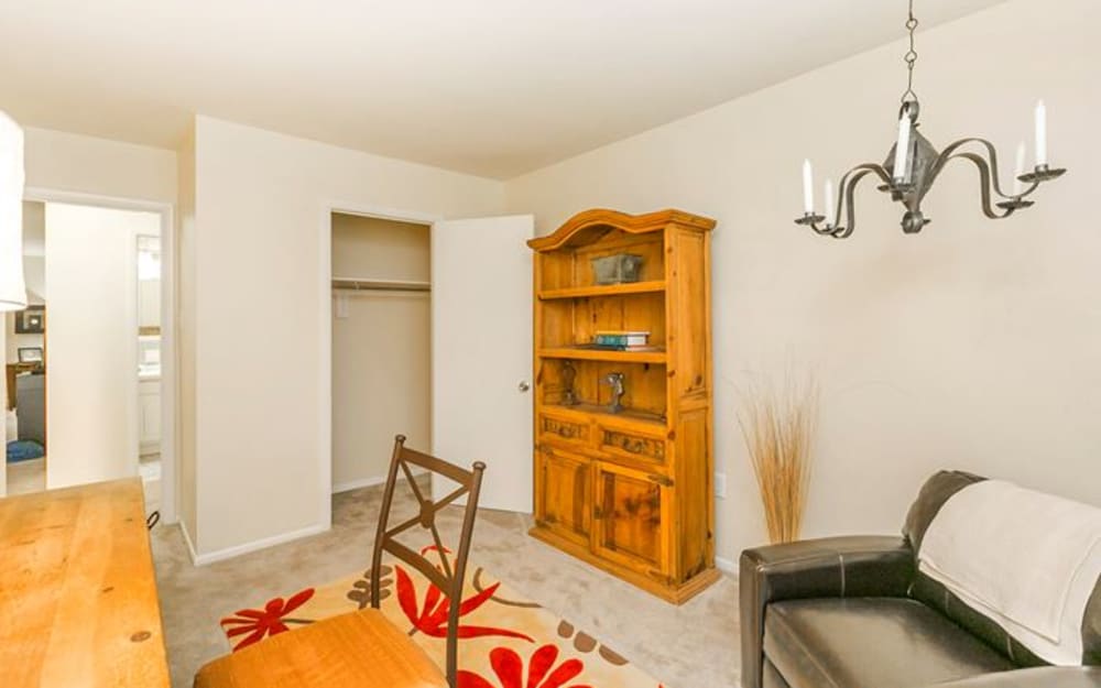 Living room with closet storage in a home at Highland Ridge Apartment Homes in High Point, North Carolina