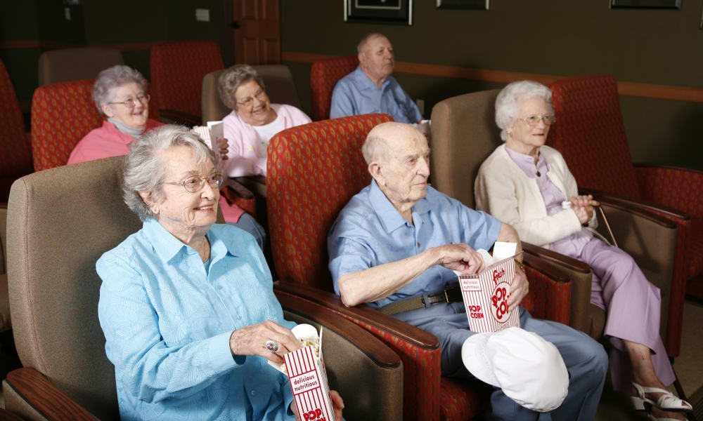 Resident watching a movie in the theater at Deer Crest Senior Living in Red Wing, Minnesota