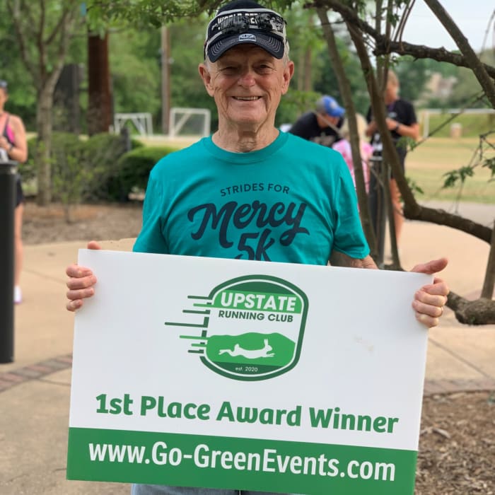 Resident showing off a running club award at The Foothills Retirement Community in Easley, South Carolina