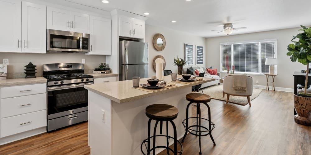 Gourmet kitchen with a breakfast bar and White shaker cabinetry at Pinebrook Apartments in Fremont, California