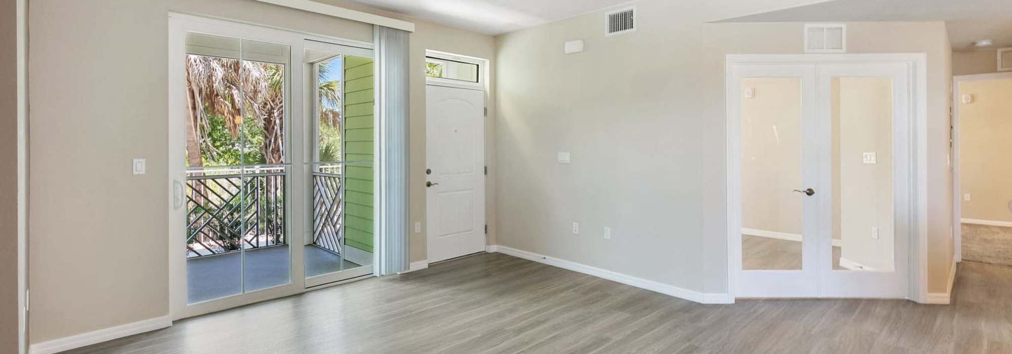 Charming living space with large windows and a welcoming entrance at Lemon Bay Apartments in Englewood, Florida.