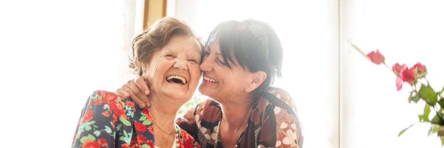 Resident laughing happily with her daughter at Edgerton Care Center in Edgerton, Wisconsin