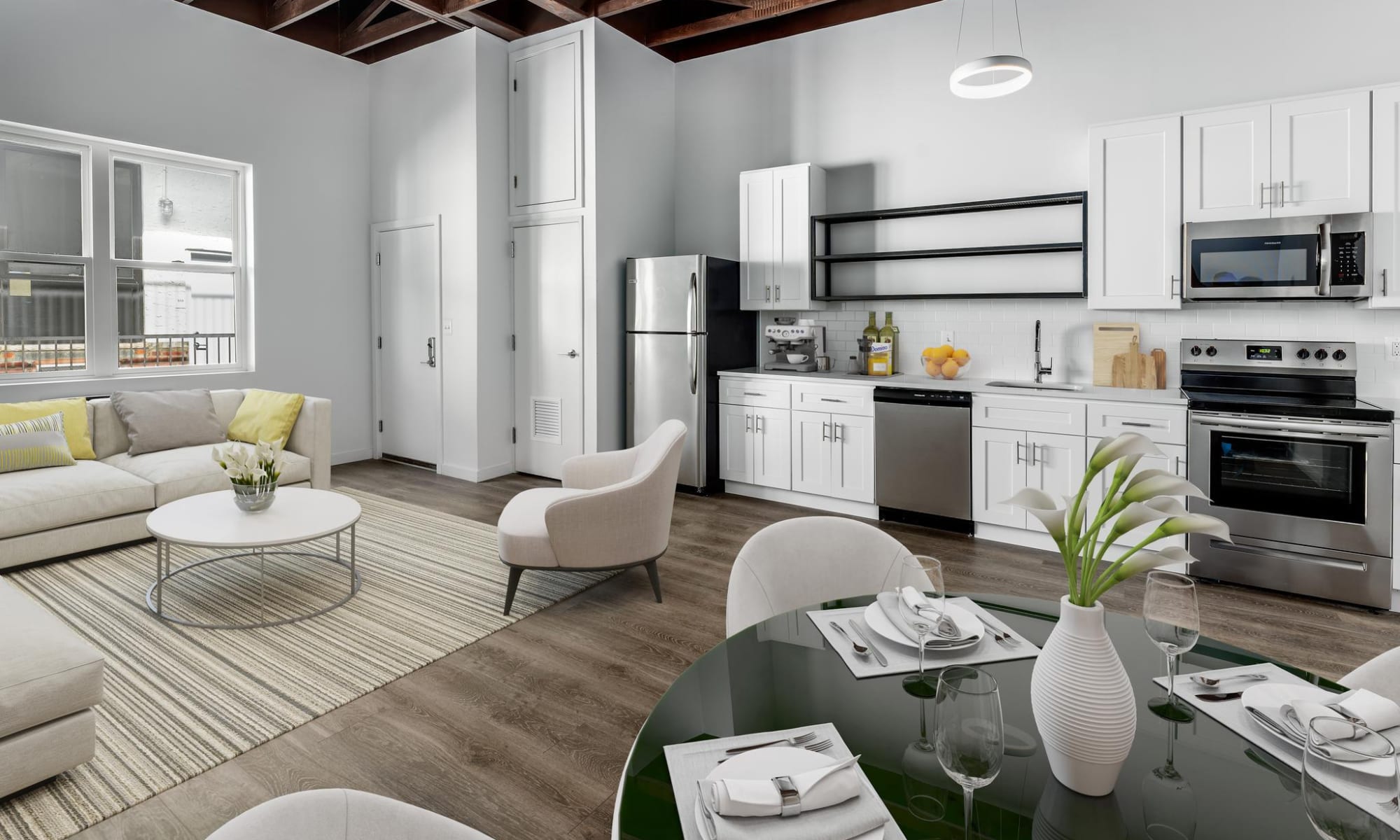 Living room with kitchen and dining at Brush Factory Lofts in Philadelphia, Pennsylvania 