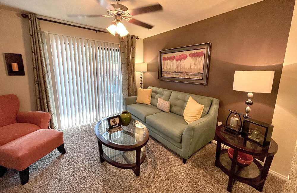 Living room with couch, chair and coffee table at The Abbey at Hightower in North Richland Hills, Texas