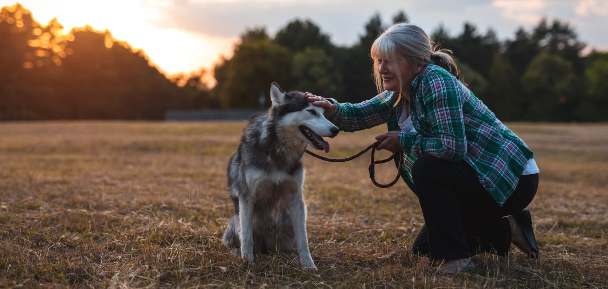 A resident petting her dog at a Stoney Brook community.