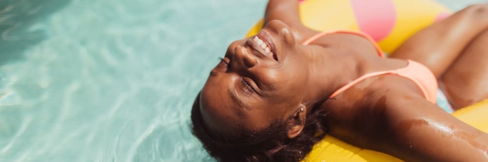 A woman relaxes in the pool at Four Seasons Apartments in Erlanger, Kentucky