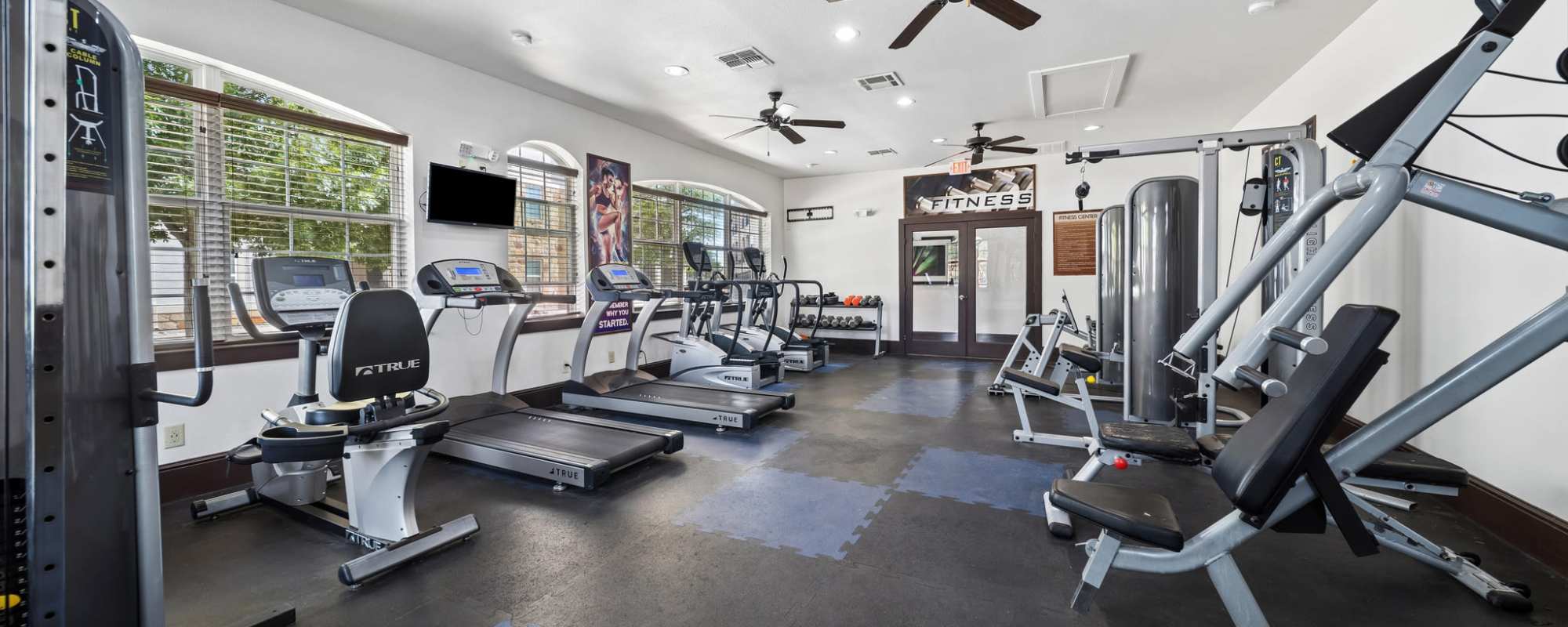 Fitness center with modern cardio equipment and weights at Sunset Lodge in Odessa, Texas