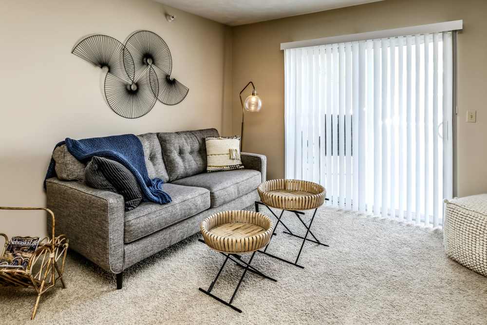 Living room with plush carpeting at The Falgrove Apartments in Omaha, Nebraska