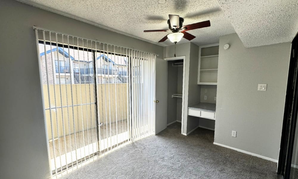 Living room with access to the patio at Santa Fe Apartments in Dallas, Texas