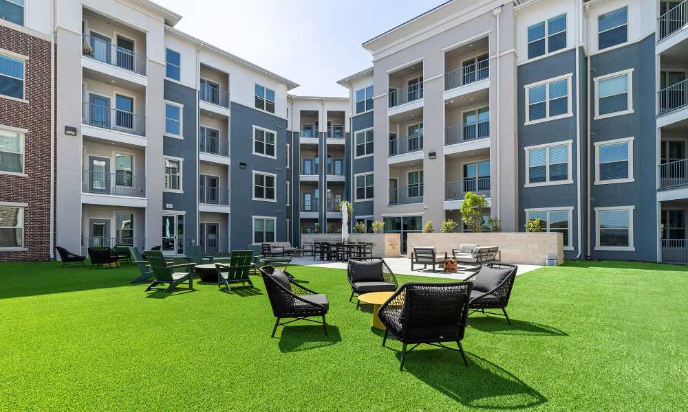 Outdoor seating with grass flooring at Main and Mill in Lewisville,Texas