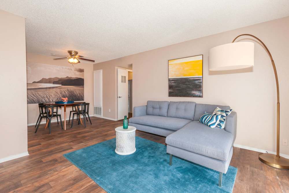 Living room with access to dining area at The Woodlands Apartments in Sacramento, California