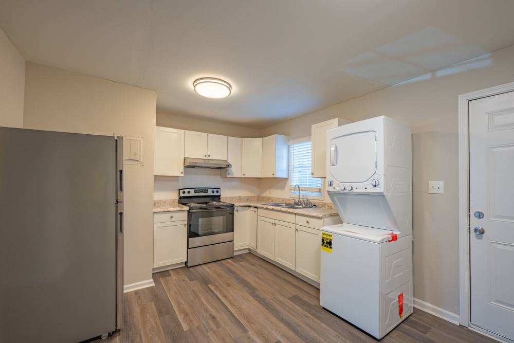 Kitchen with attached stacked washer and dryer at Ivey Ridge Apartments in Graham, North Carolina