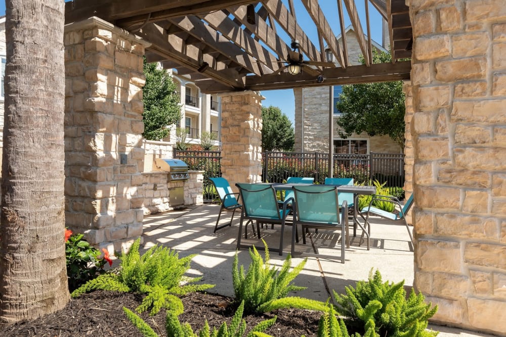Barbecue area with gas grills overlooking the swimming pool at The Retreat at Cinco Ranch in Katy, Texas