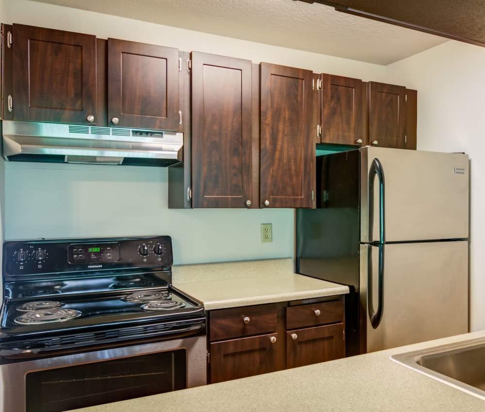Kitchen with wooden cabinets at Ansley Murrayhill in Tigard, Oregon