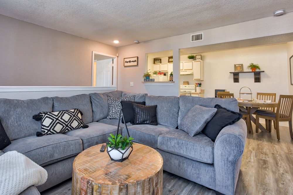 Cozy living room with a couch and table at The Gardens At Duncan Apartments in Duncan, Oklahoma