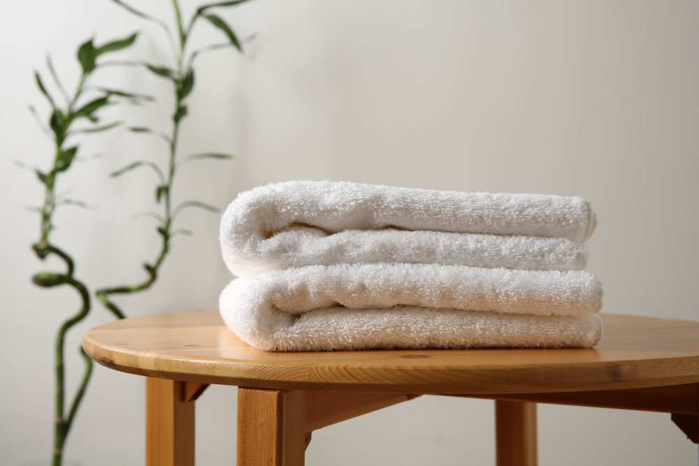 Stack of fluffy towels on a wooden table at The Residences at Talcott in Weatogue, Connecticut
