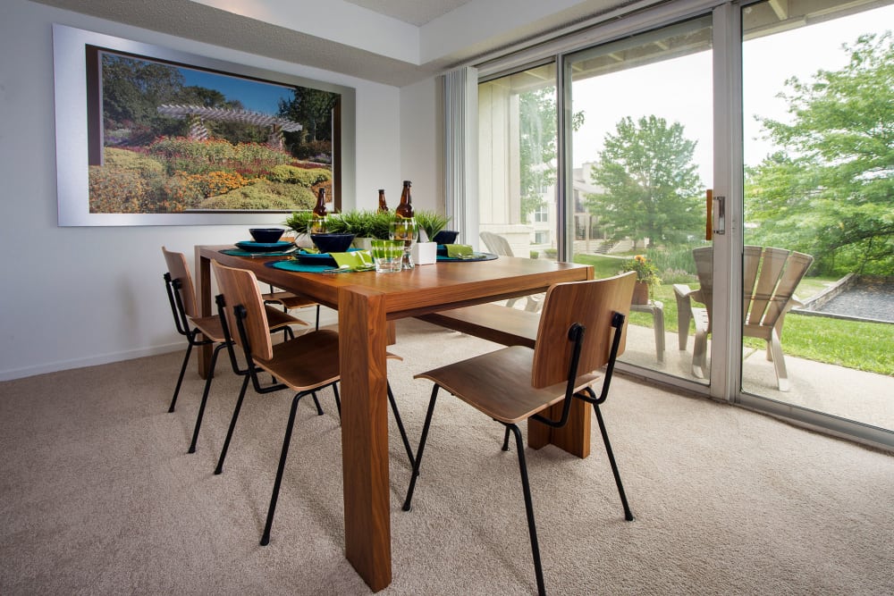 Dining room with a tree-lined view at Briar Cove Terrace Apartments in Ann Arbor, Michigan