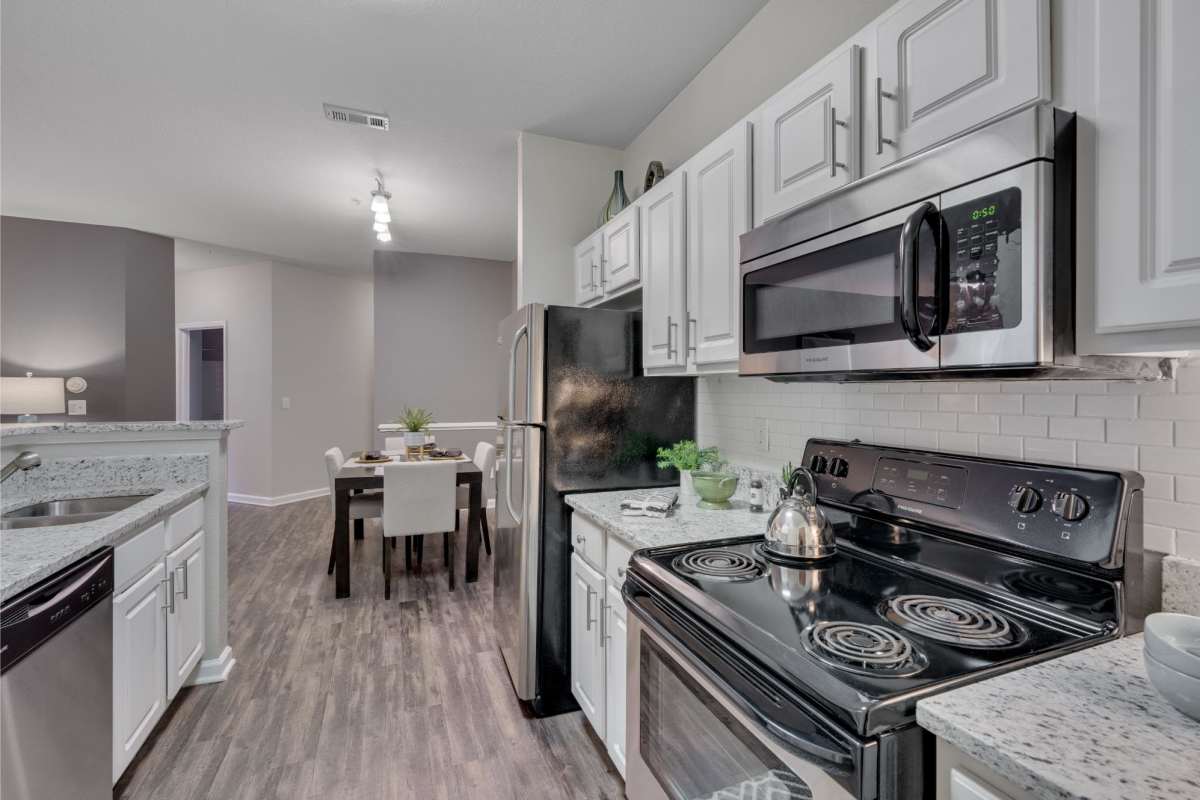 Kitchen with stainless-steel appliances at Weston Reserve Apartments in Morrisville, North Carolina