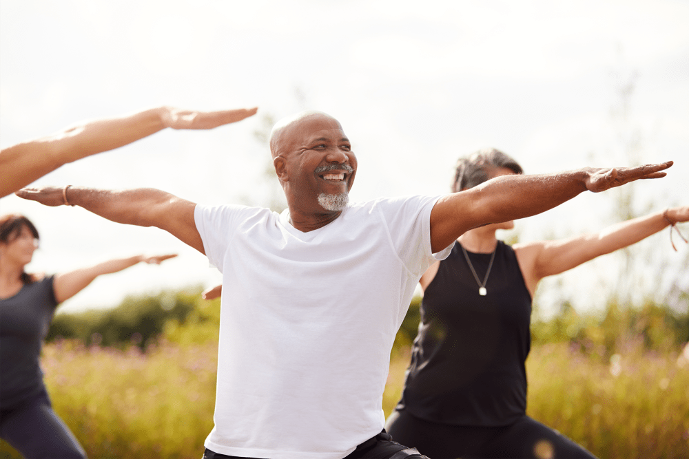 Residents doing yoga outdoors at The Colonials Apartment Homes in Cherry Hill, New Jersey