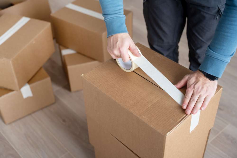 Person packing boxes at American Self Storage in Raymore Missouri