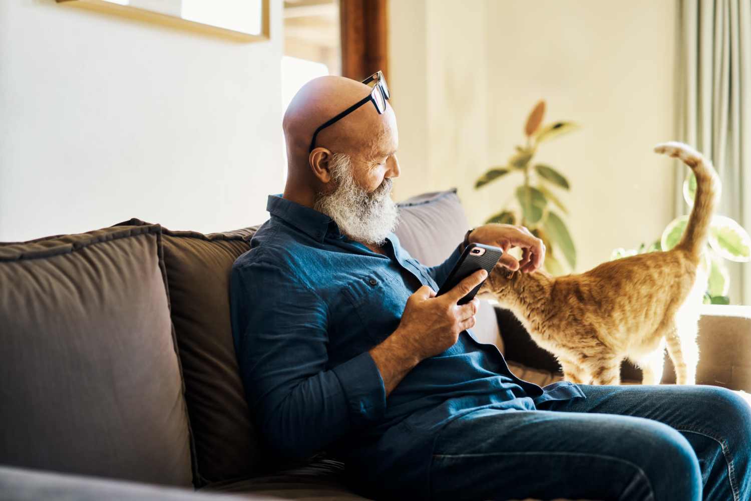 Resident with his pet cat in the apartment at Arioso in Las Vegas, Nevada