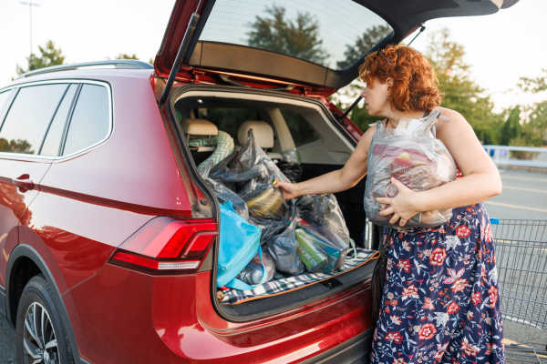 Woman unloading groceries from car trunk at Treehaven in Summerville, South Carolina