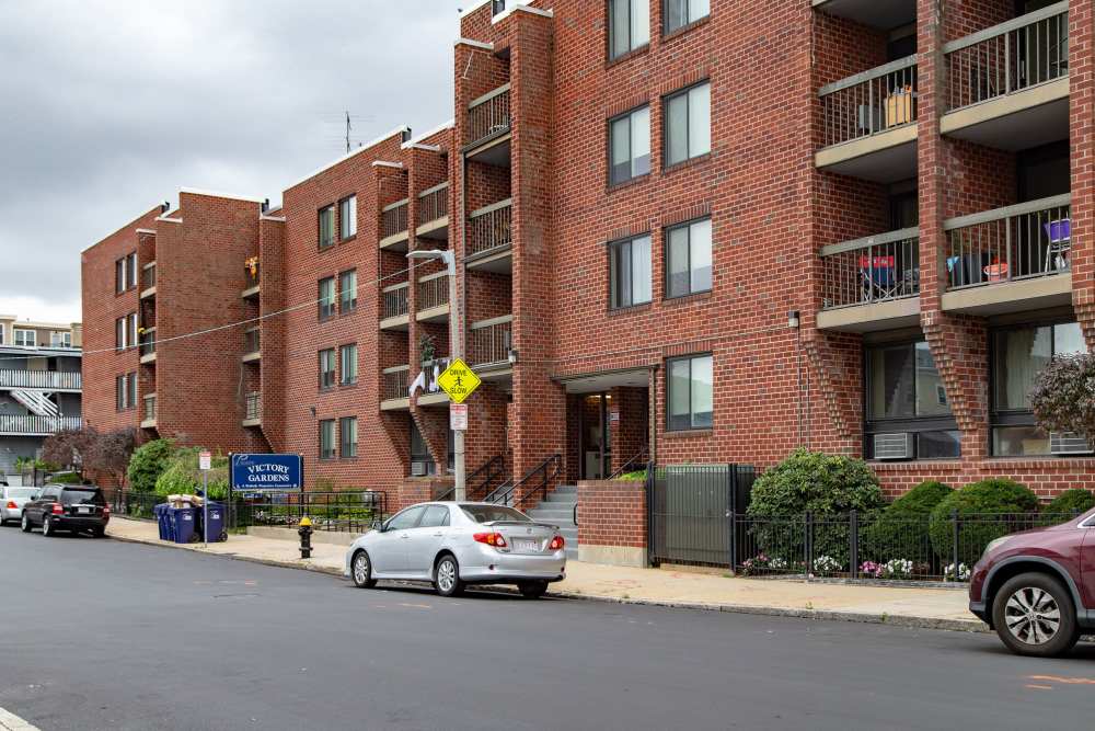 Brick apartment building with balconies at Victory Gardens in East Boston, Massachusetts