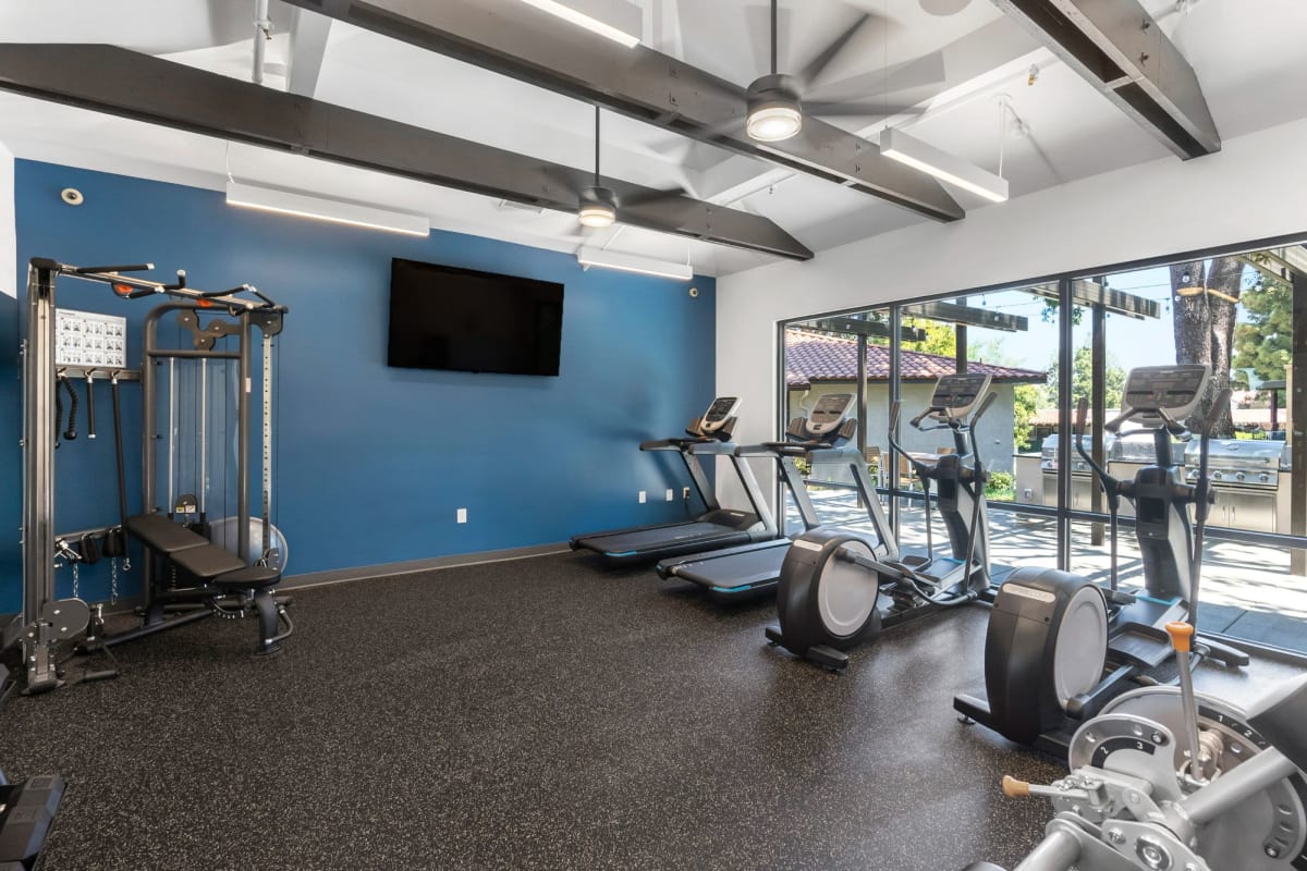 Fitness center with large windows at Los Robles Apartments, Thousand Oaks, California