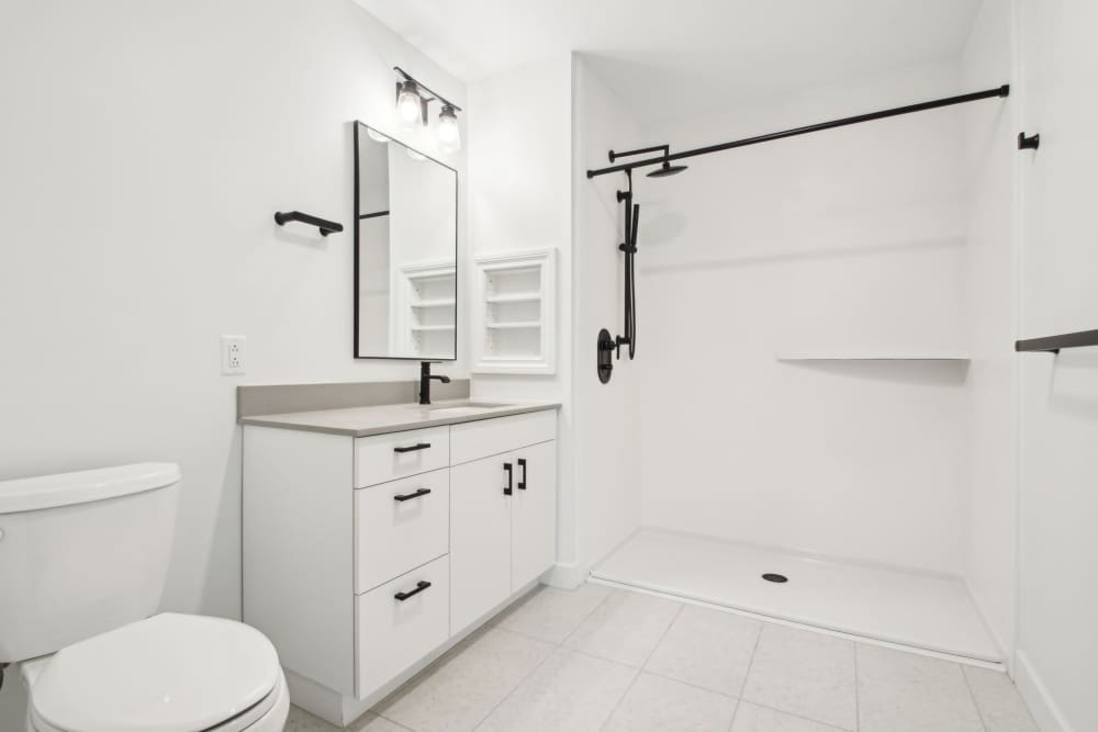 Well-lit apartment bathroom at The Edmond in Rochester, New York