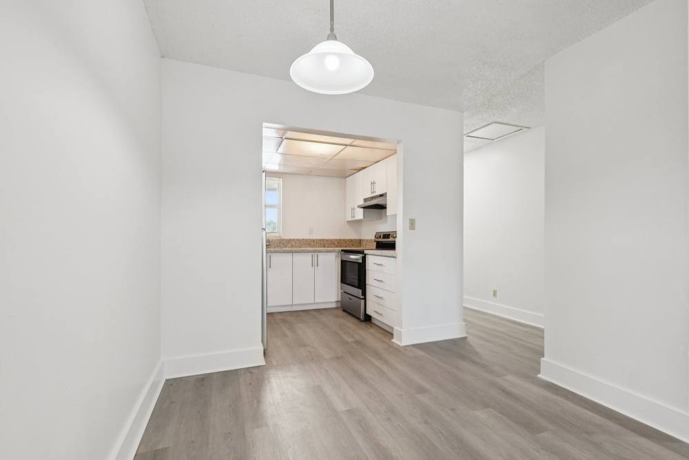 View of kitchen from living area at El Jardin Apartments in Hollywood, Florida