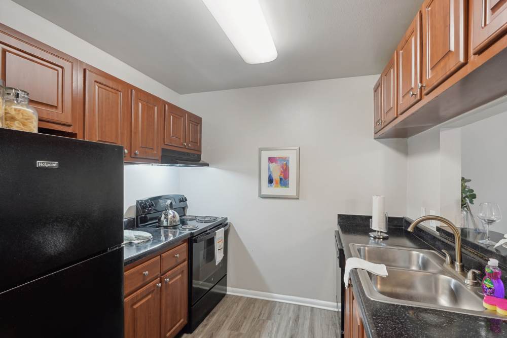 Garden style kitchen with dark wood cabinets at Lake Forest in Daytona Beach, Florida