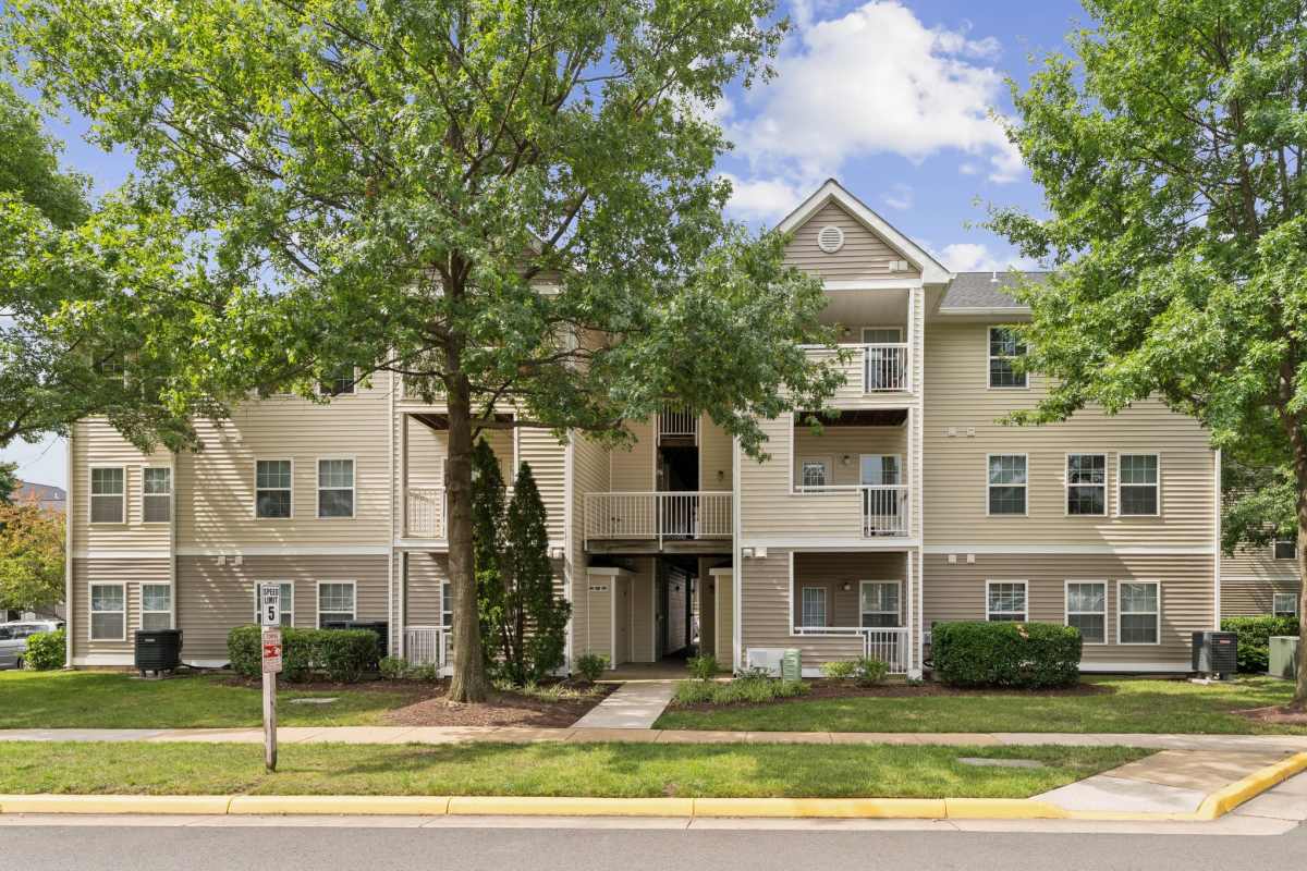 Exterior view of apartments with walkway at Dulles Center Apartments in Herndon, Virginia