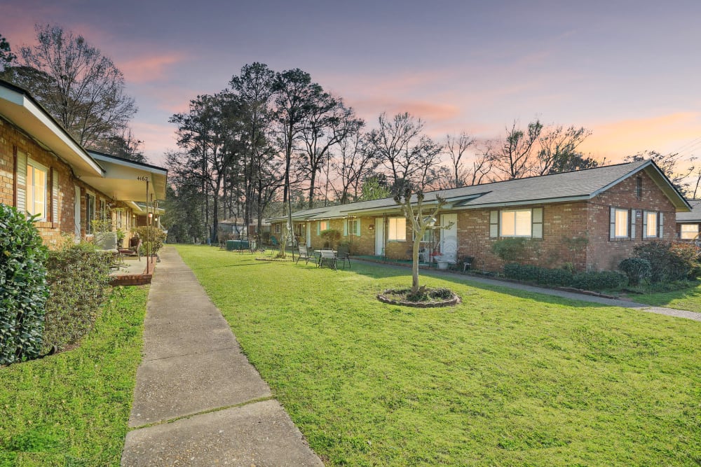 A paved walkway between apartments at Alpine Apartment Homes in Columbus, Georgia