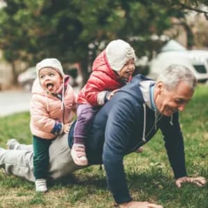 Resident playing with his young grandchildren at King City Senior Village in King City, Oregon