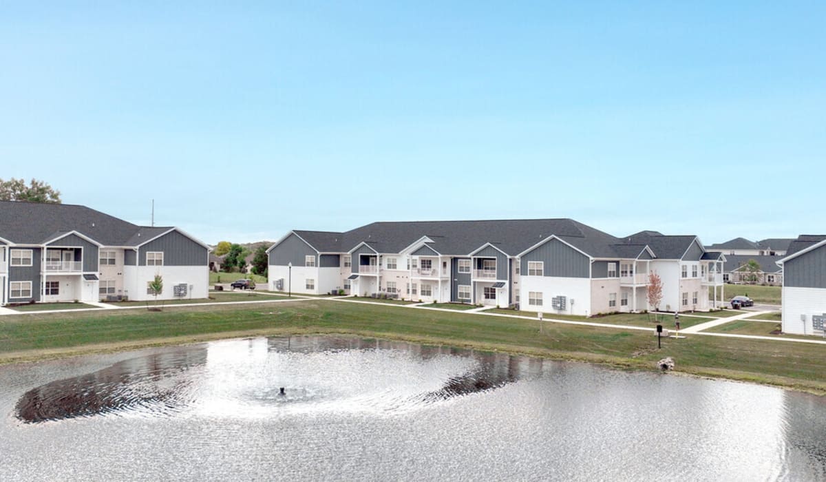 Exterior view of the apartment with a lake at Union Club Apartments in Fort Wayne, Indiana