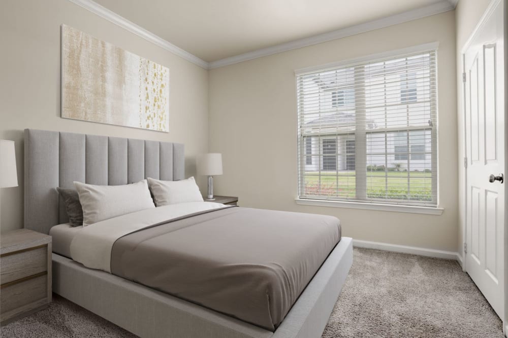 Well lit and carpeted bedroom at Olympus Woodbridge in Sachse, Texas