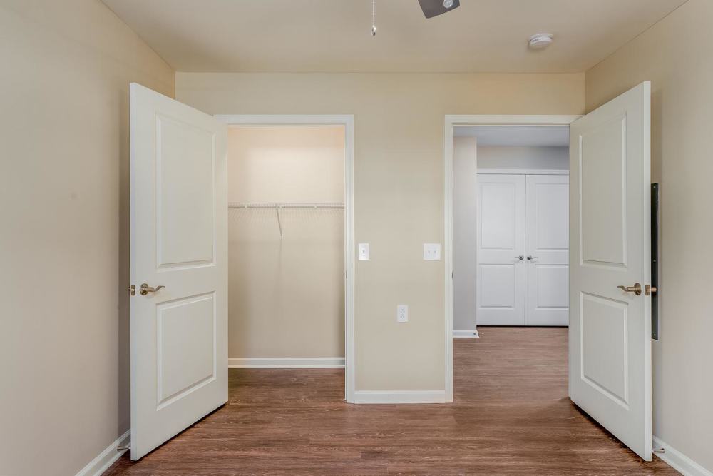 Spacious entryway with wood-style flooring and two open doors leading to closets at Owens Greene in Wheeling, West Virginia