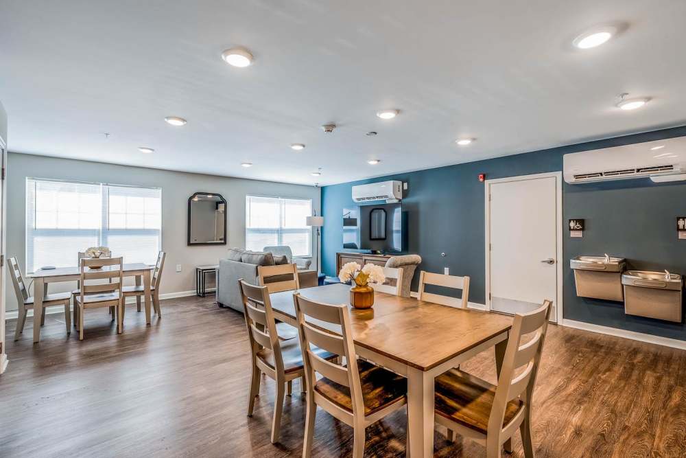 Bright open layout with wood-style flooring, dining area, and comfortable seating in living space at Owens Greene in Wheeling, West Virginia