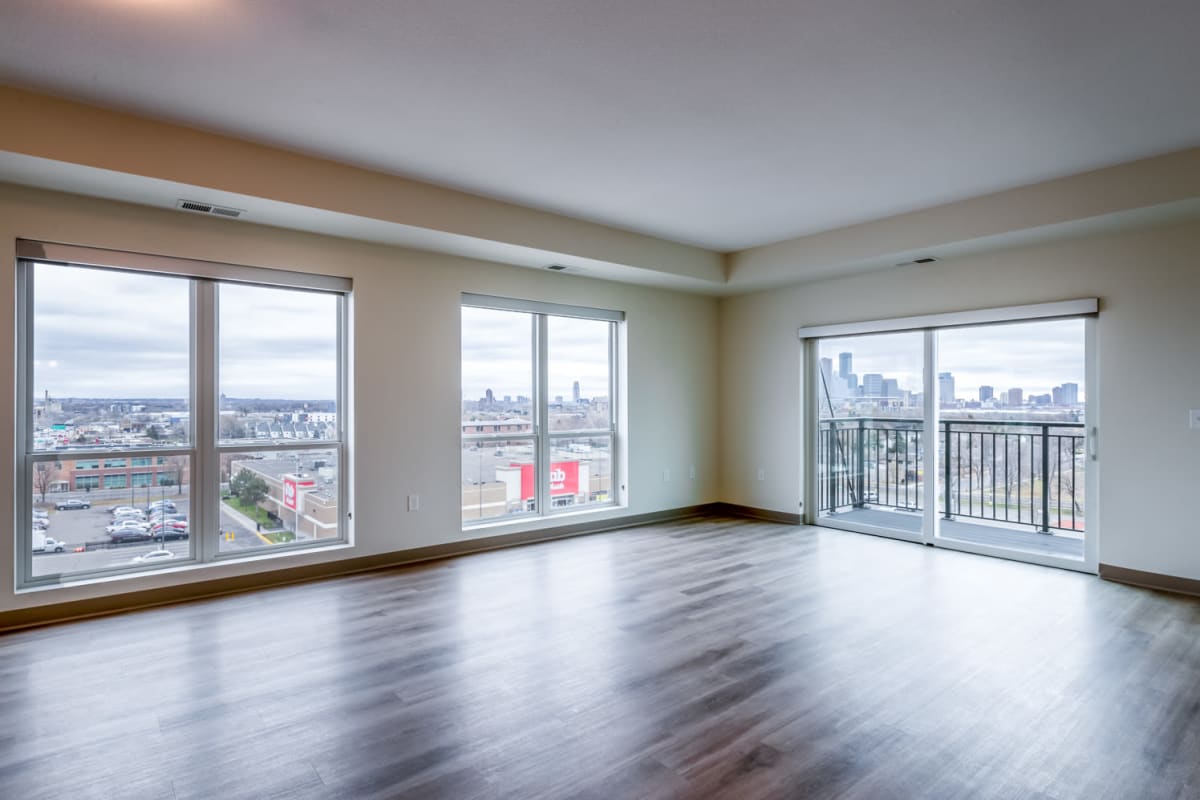 Spacious living room with wood-style flooring at Satori Apartments in Minneapolis, Minnesota