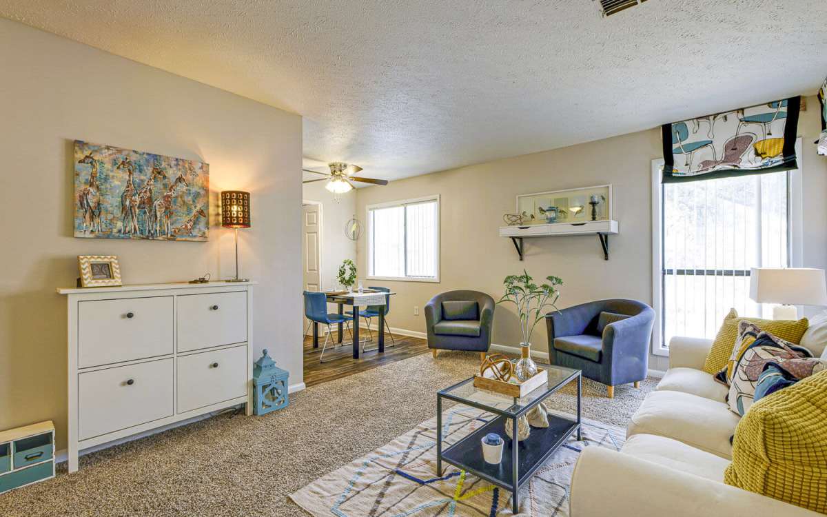 Well-furnished apartment living room with chairs and carpet flooring at Landmark Flats in Fayetteville, North Carolina