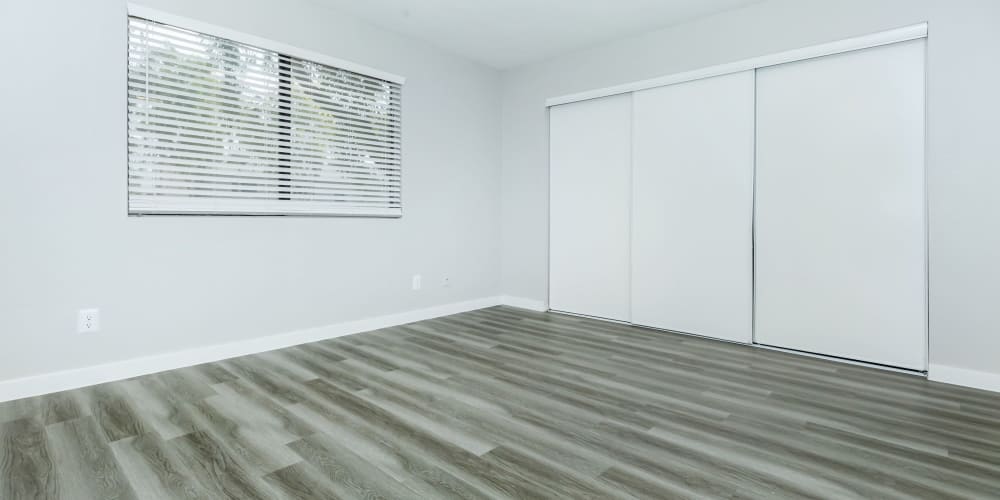 Bedroom with wood-style flooring and a large window at Tides on Palm in Las Vegas, Nevada