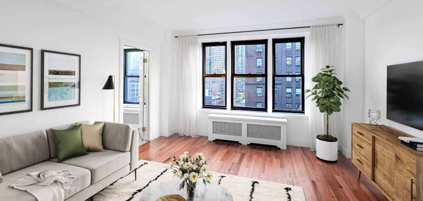 living room with triple window view at The Sutton Collection in New York, New York